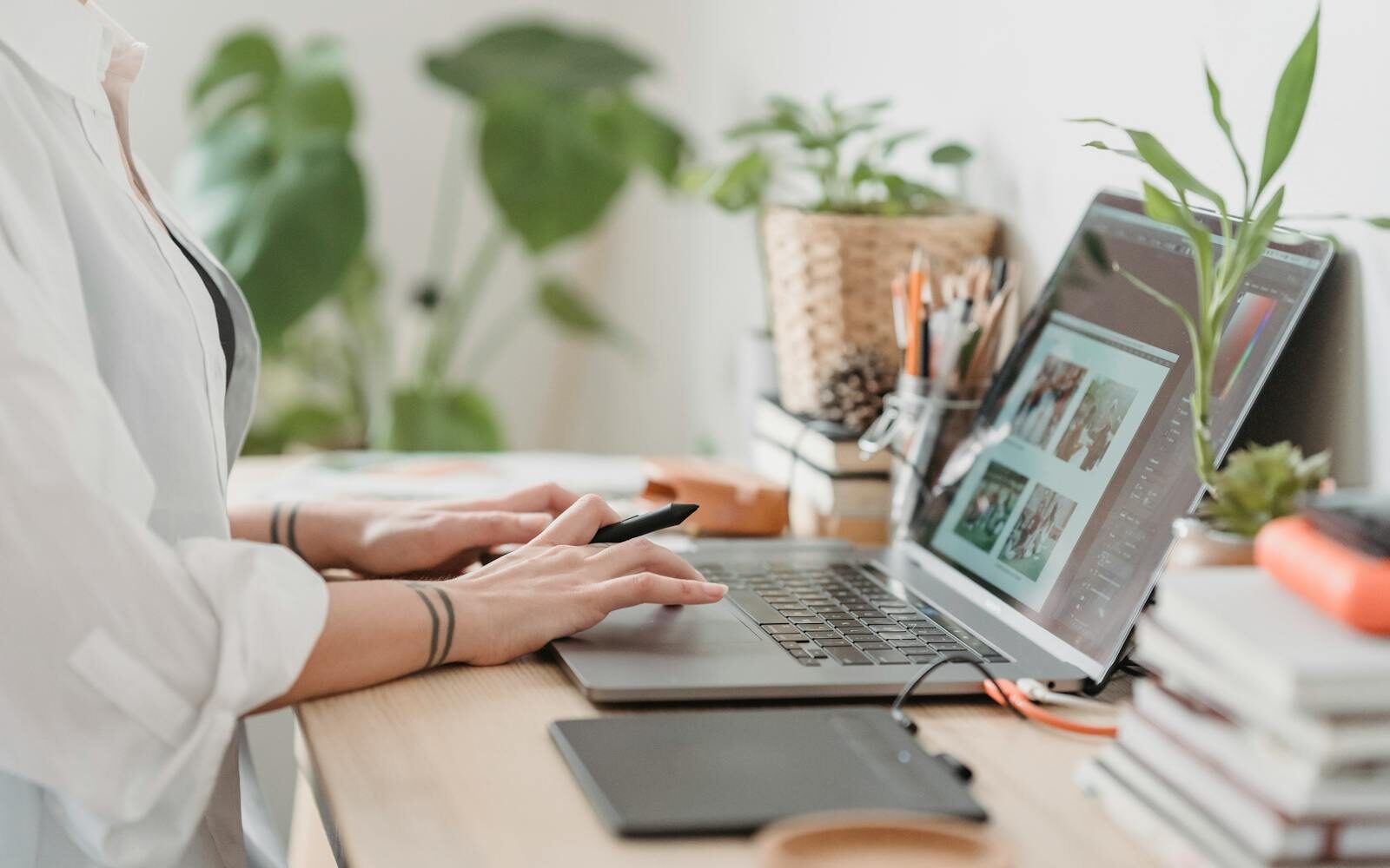 Woman working retouching photo on laptop at convenient workplace